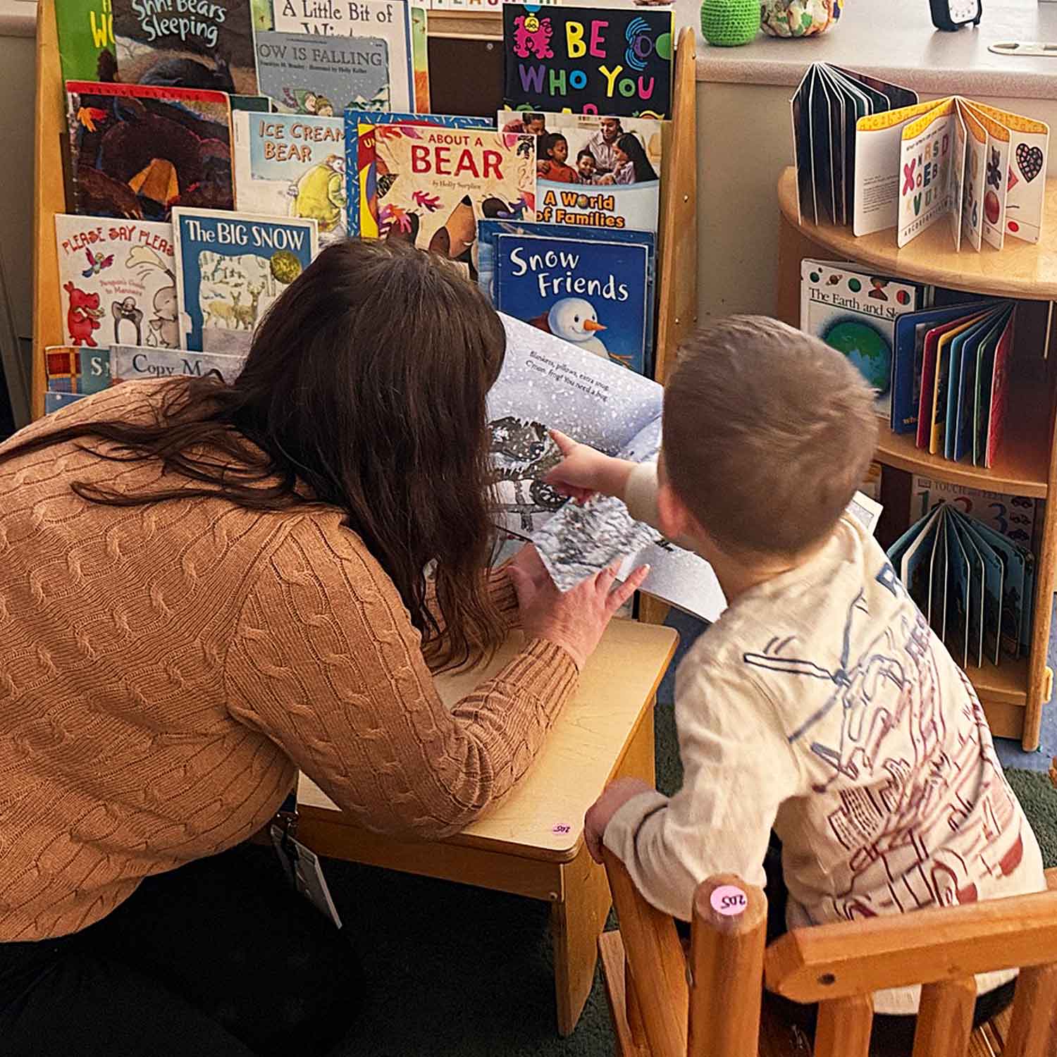 Teacher working with young boy